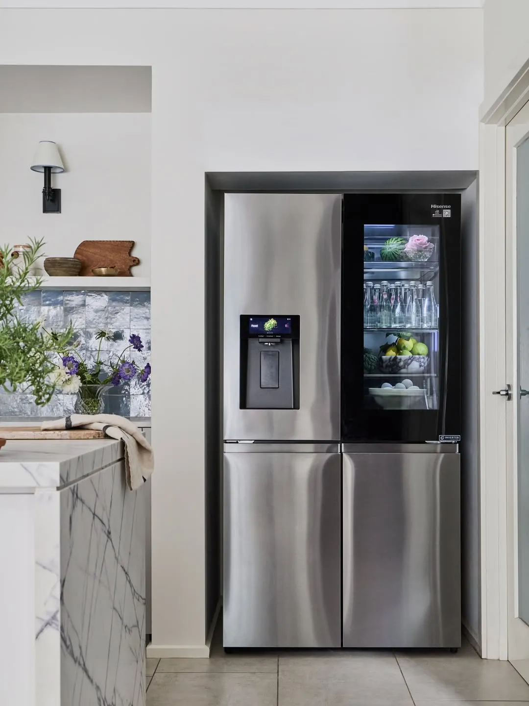 A Stylish Stainless Steel Refrigerator Placed in a Kitchen Corner